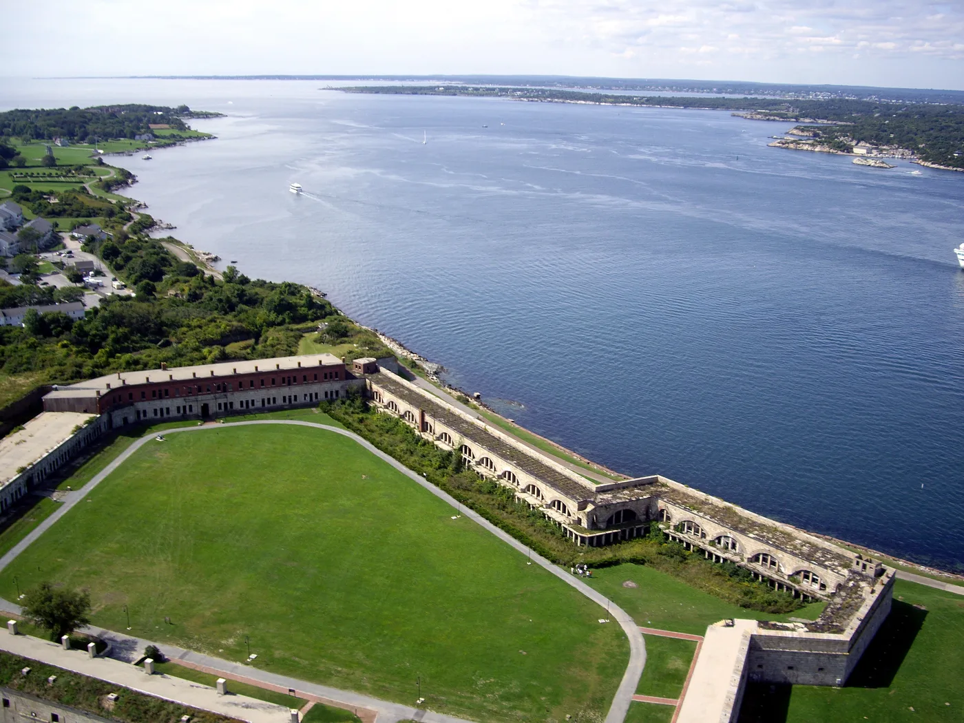 Aerial view of Fort Adams, its parade field and stone walls beside Narragansett Bay